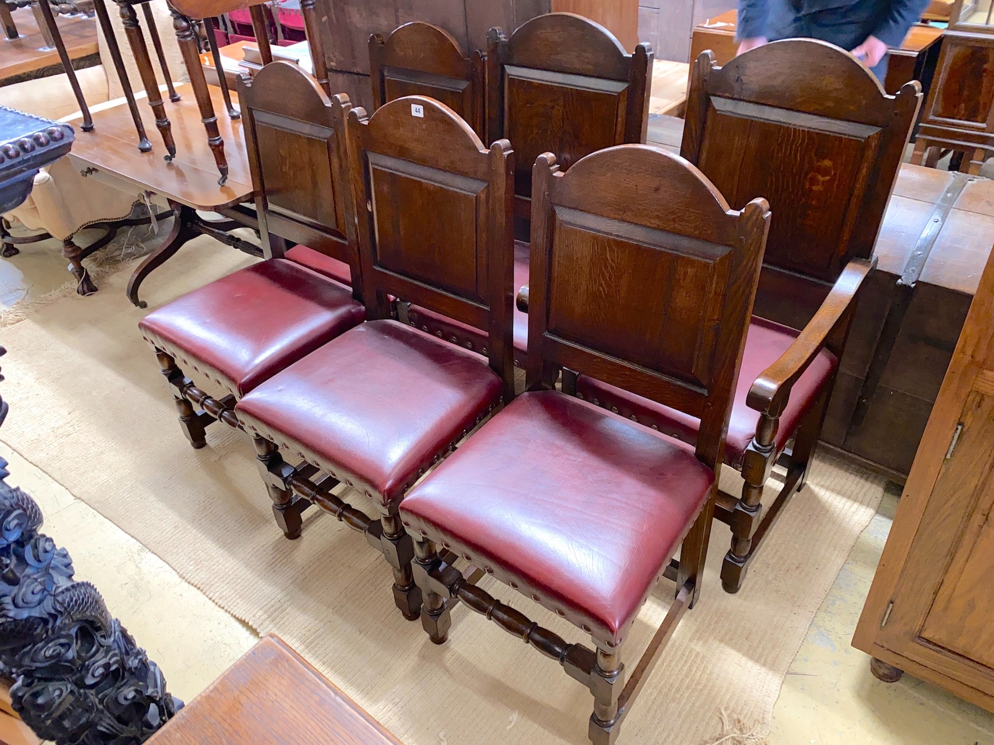 A set of six 18th century style panelled oak dining chairs, two with arms